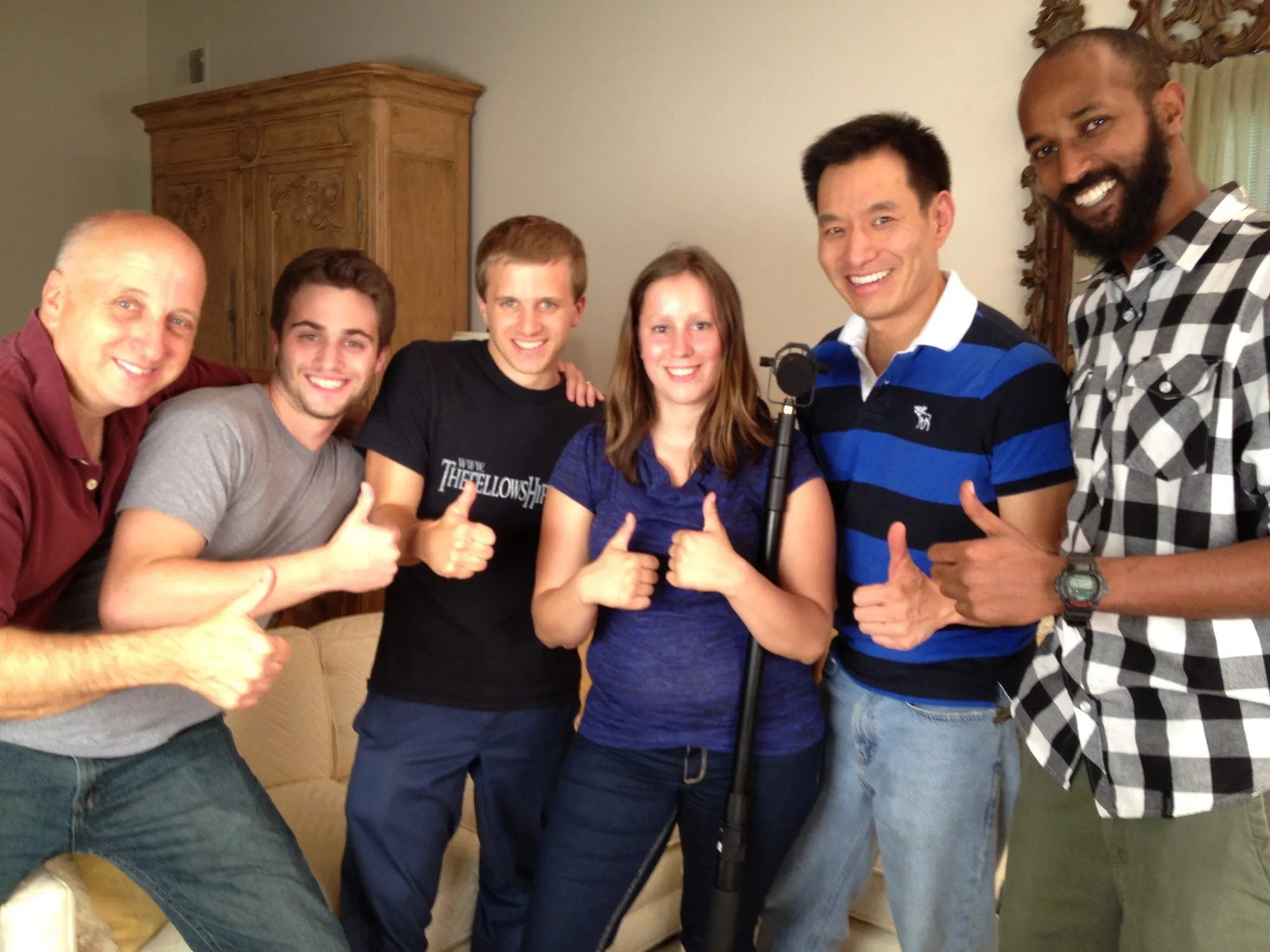 The production crew for the JFGH gala video, six people giving a thumbs-up in a living room.